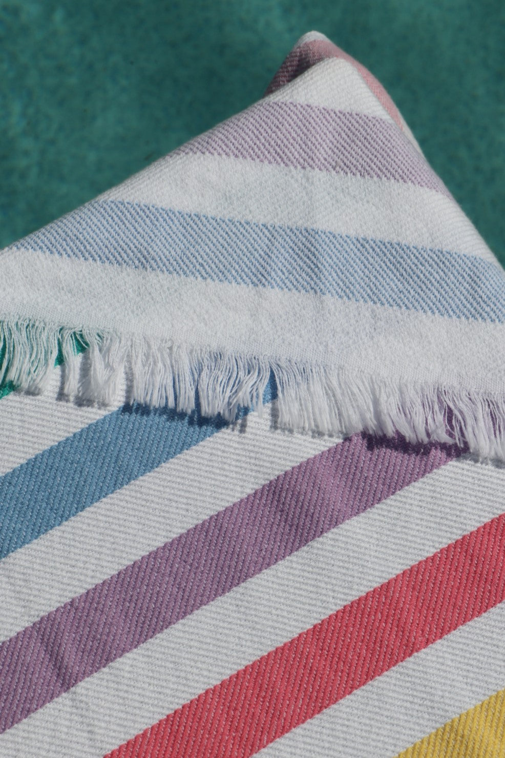 Rainbow turkish towel close up, green blue lilac watermelon yellow stripes