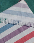 Rainbow turkish towel close up, green blue lilac watermelon yellow stripes